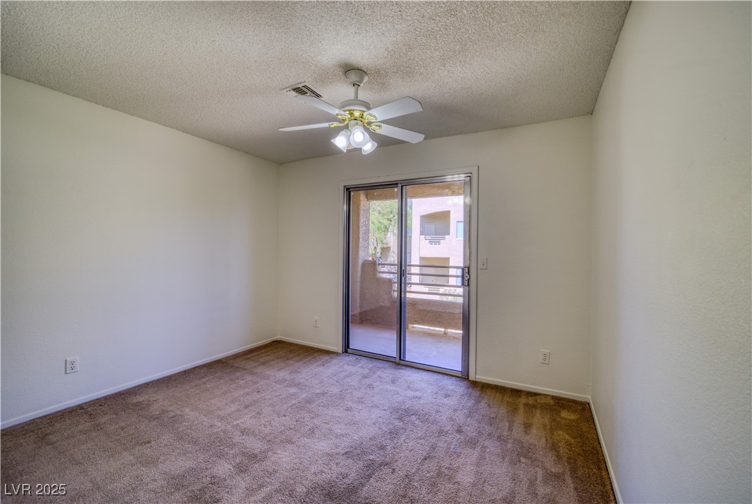 2232 Aspen Mirror Way, Unit 202 Laughlin, NV 89029 - Photo 25 of 39 Carpeted 2nd bedroom featuring a textured ceiling and ceiling fan