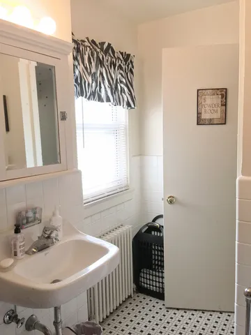 a bathroom with a sink and a window