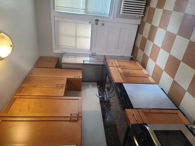 a kitchen with a sink and a stove top oven