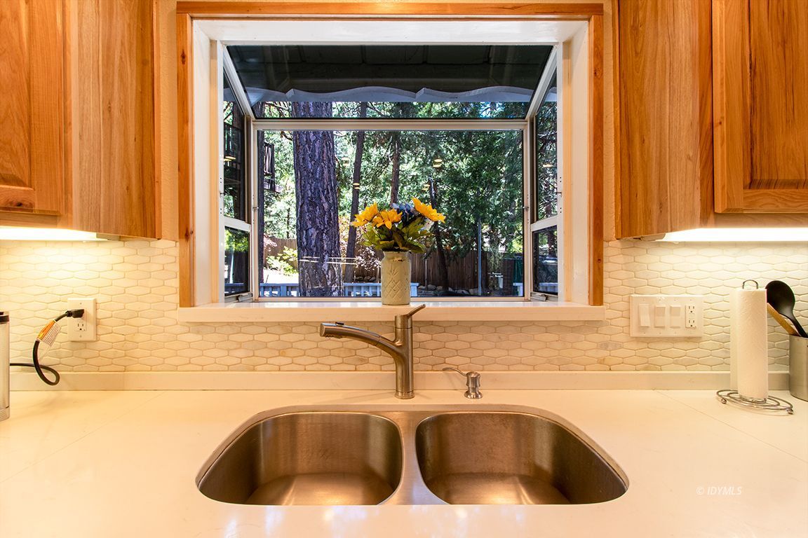 25104 Fern Valley Road Idyllwild, CA 92549 - Photo 11 of 55 a kitchen with a sink and a large window