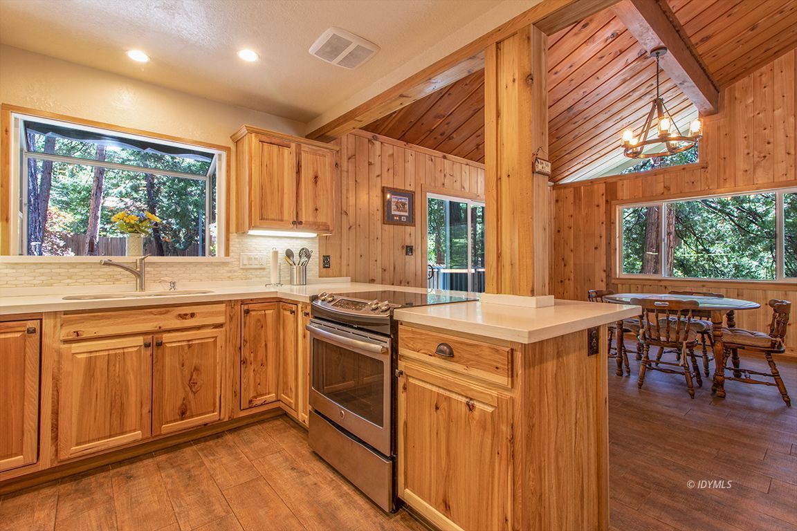 25104 Fern Valley Road Idyllwild, CA 92549 - Photo 14 of 55 a kitchen with a stove a sink and a refrigerator