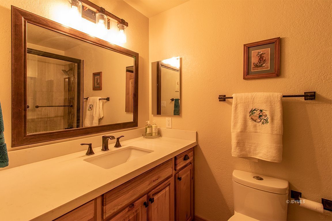 25104 Fern Valley Road Idyllwild, CA 92549 - Photo 22 of 55 a bathroom with a sink and mirror with toilet