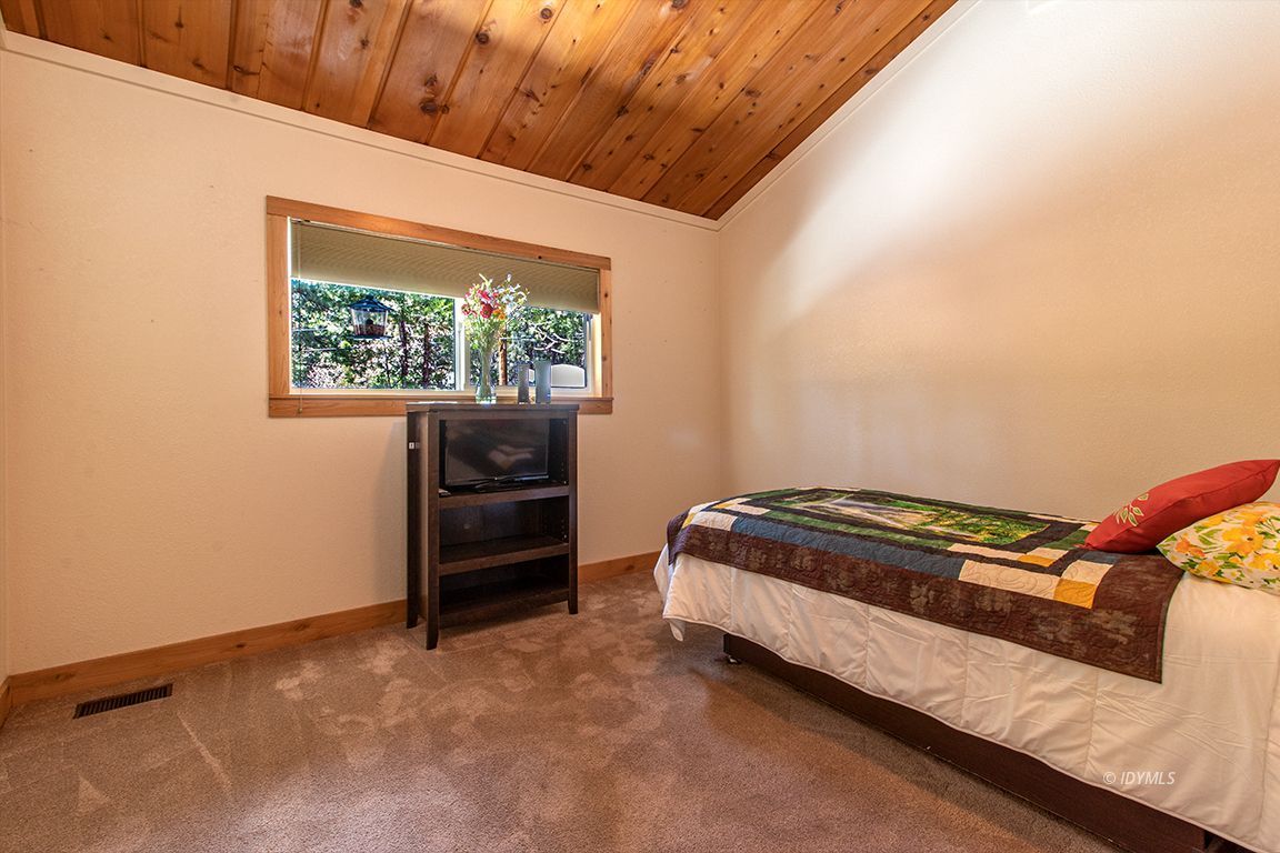 25104 Fern Valley Road Idyllwild, CA 92549 - Photo 23 of 55 a bedroom with a bed and a window