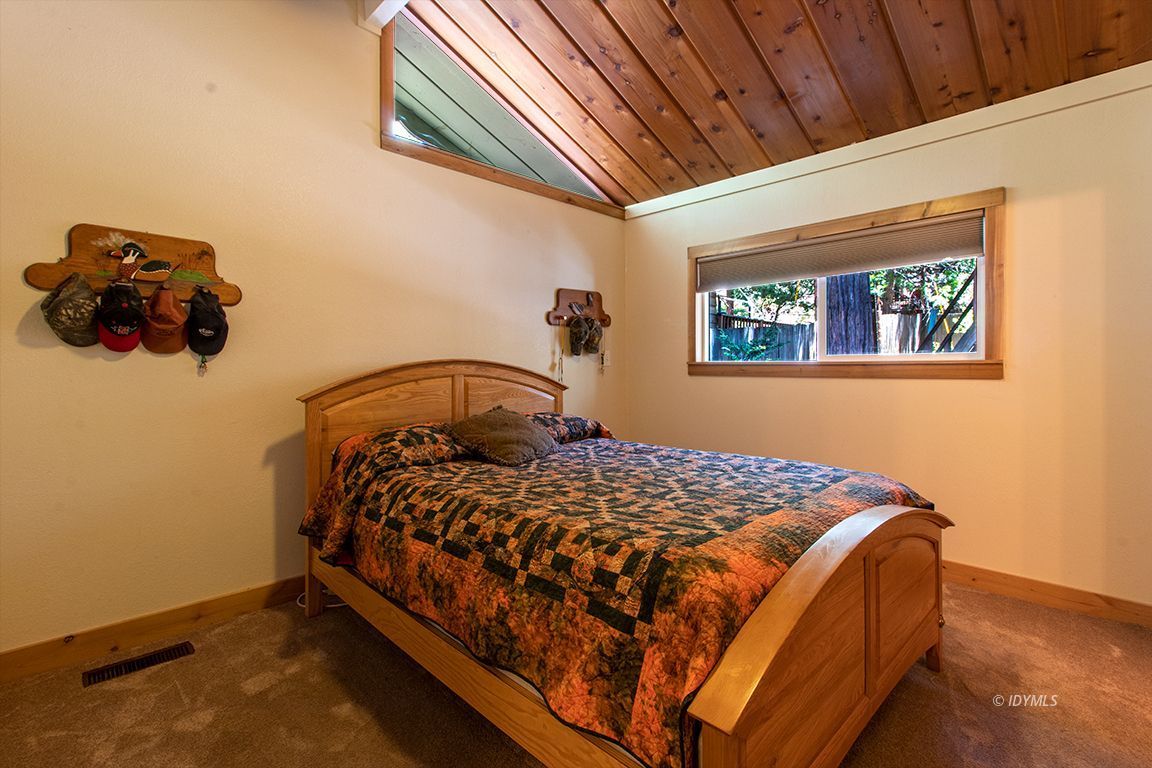 25104 Fern Valley Road Idyllwild, CA 92549 - Photo 24 of 55 a bed sitting in a bedroom next to a window