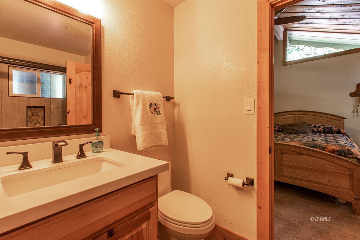 25104 Fern Valley Road Idyllwild, CA 92549 - Photo 25 of 55 a bathroom with a granite countertop sink toilet and shower