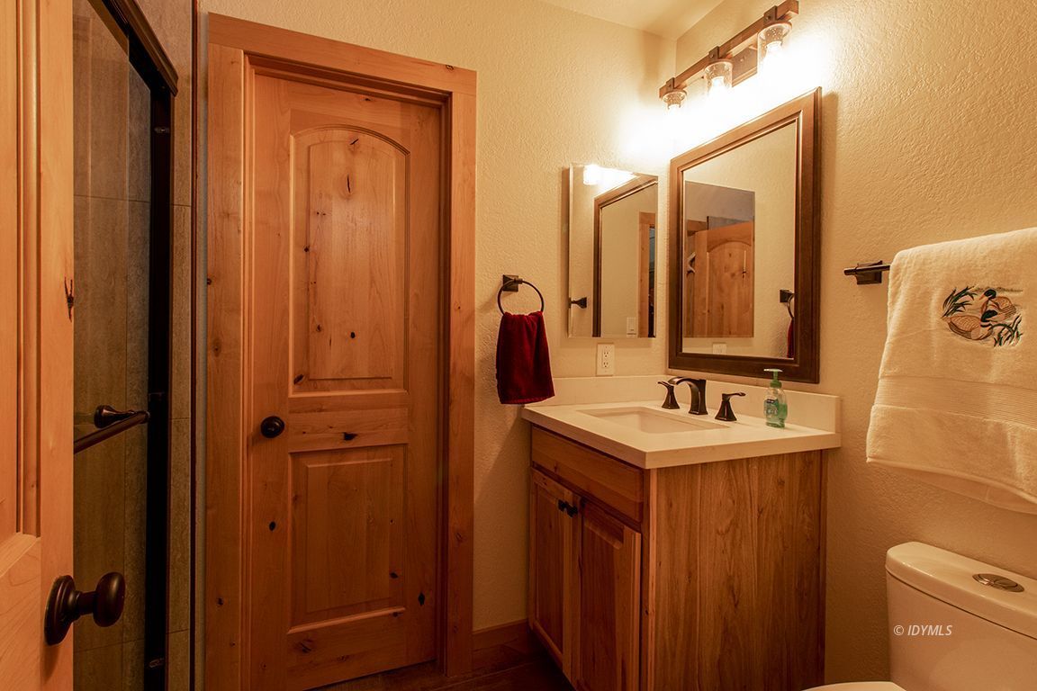 25104 Fern Valley Road Idyllwild, CA 92549 - Photo 27 of 55 a bathroom with a sink a toilet and mirror