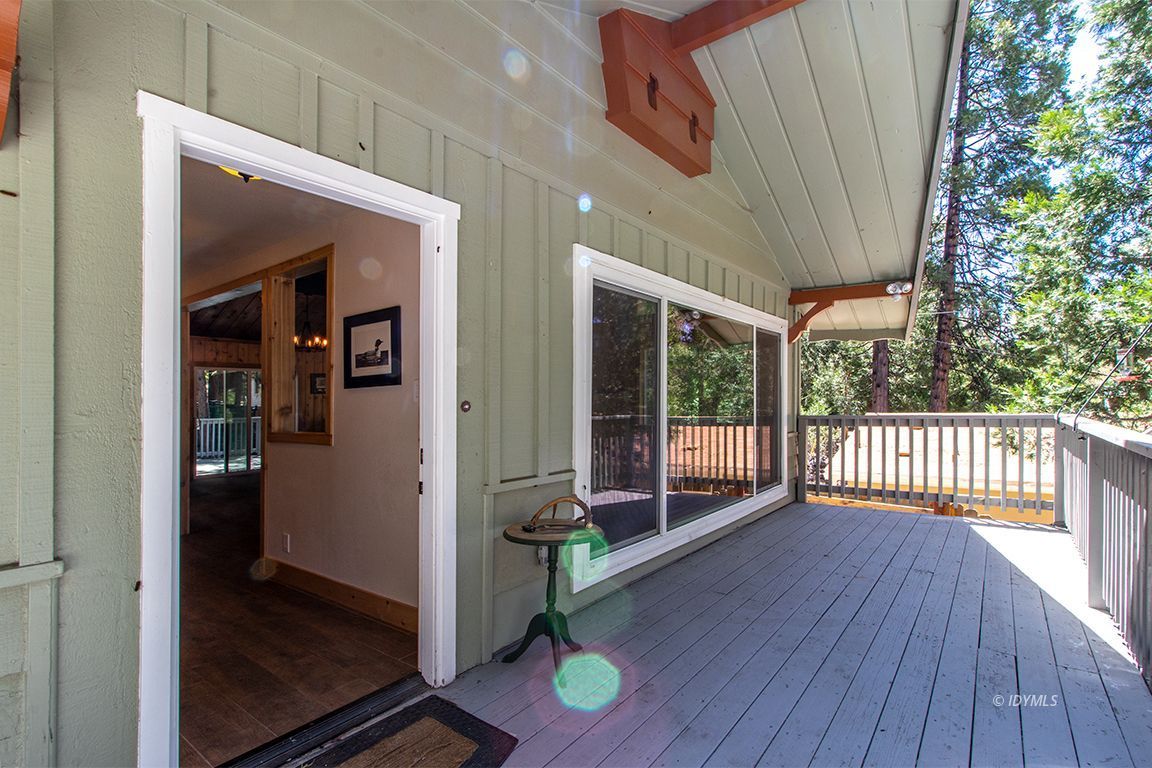 25104 Fern Valley Road Idyllwild, CA 92549 - Photo 34 of 55 a view of a porch with wooden floor and outdoor space
