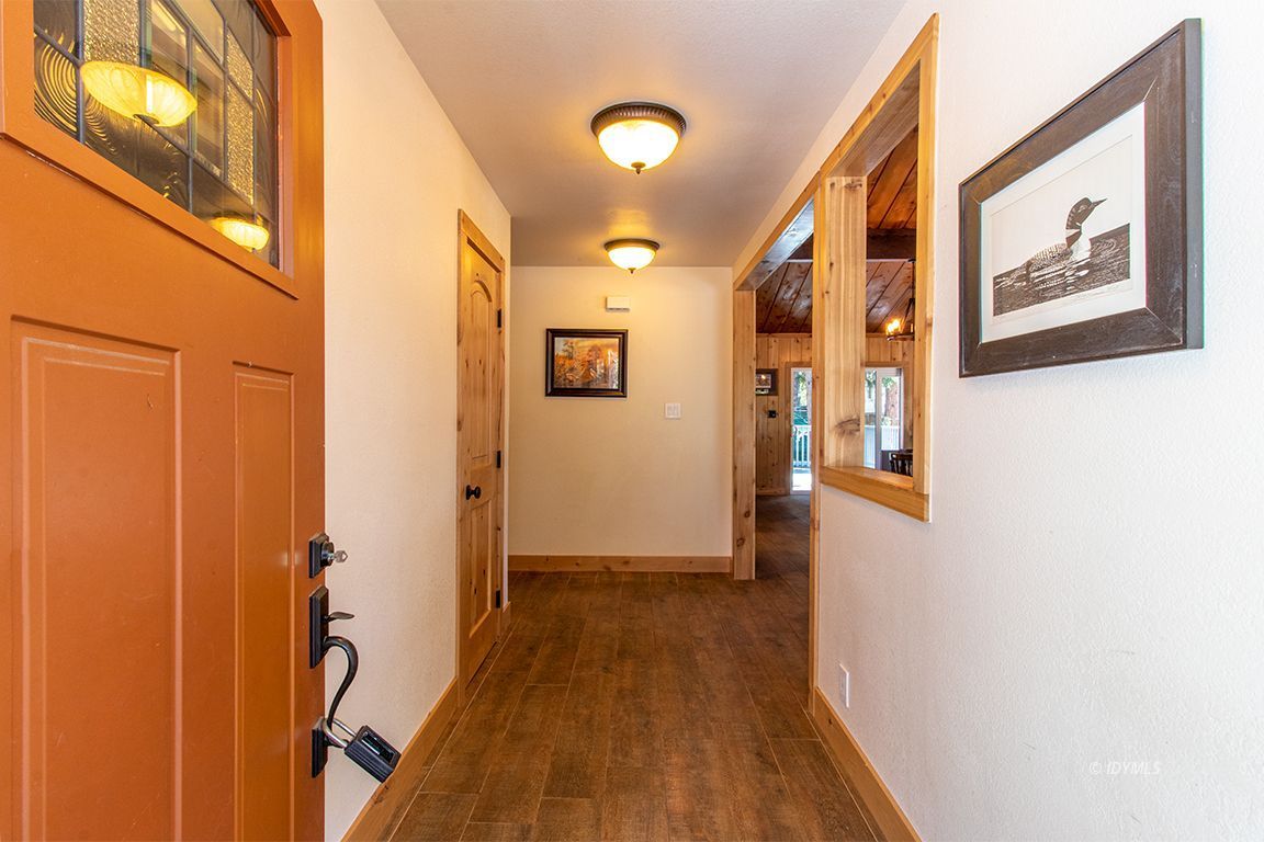 25104 Fern Valley Road Idyllwild, CA 92549 - Photo 35 of 55 a view of a hallway with wooden floor and staircase