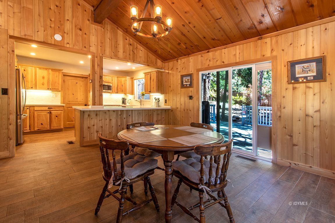 25104 Fern Valley Road Idyllwild, CA 92549 - Photo 6 of 55 a dining hall with stainless steel appliances a dining table and chairs with wooden floor