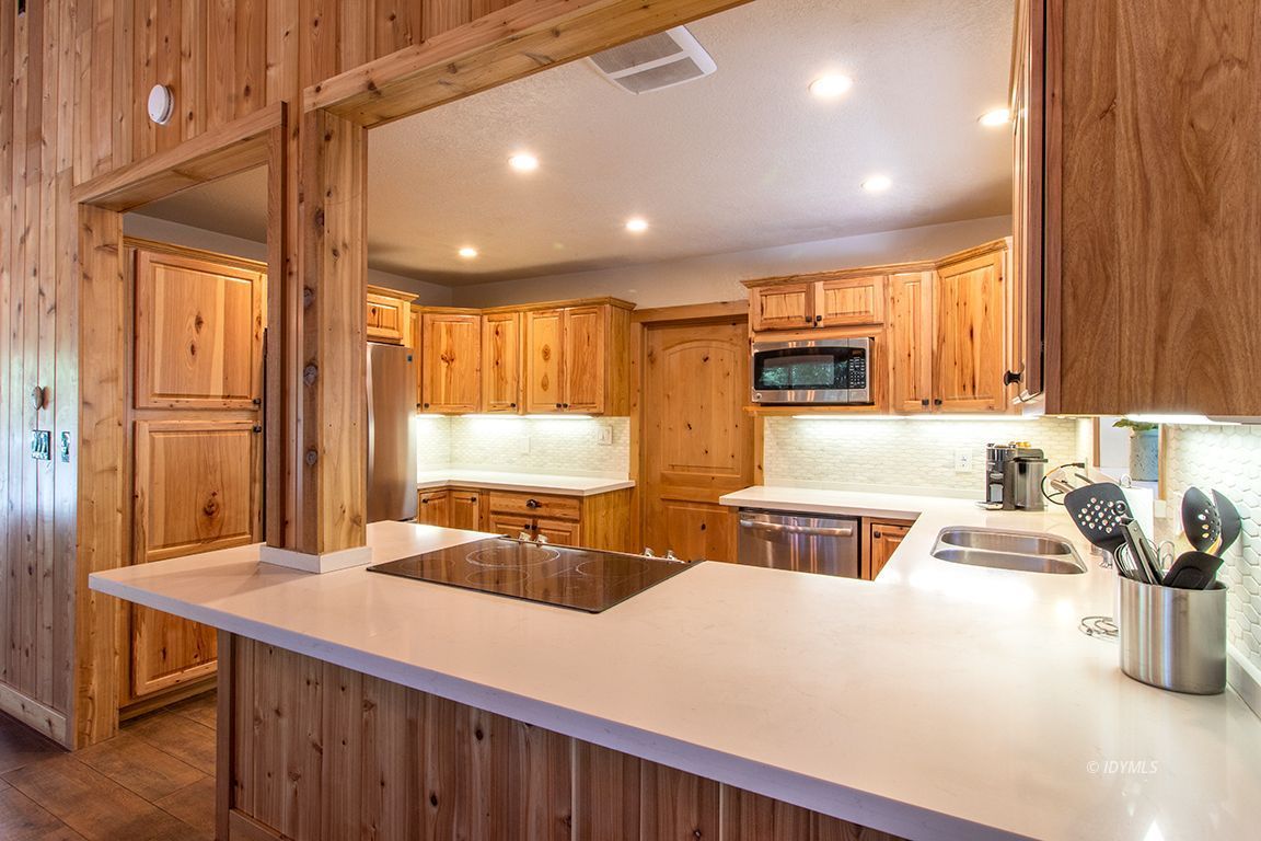 25104 Fern Valley Road Idyllwild, CA 92549 - Photo 9 of 55 a kitchen with sink a refrigerator and chairs