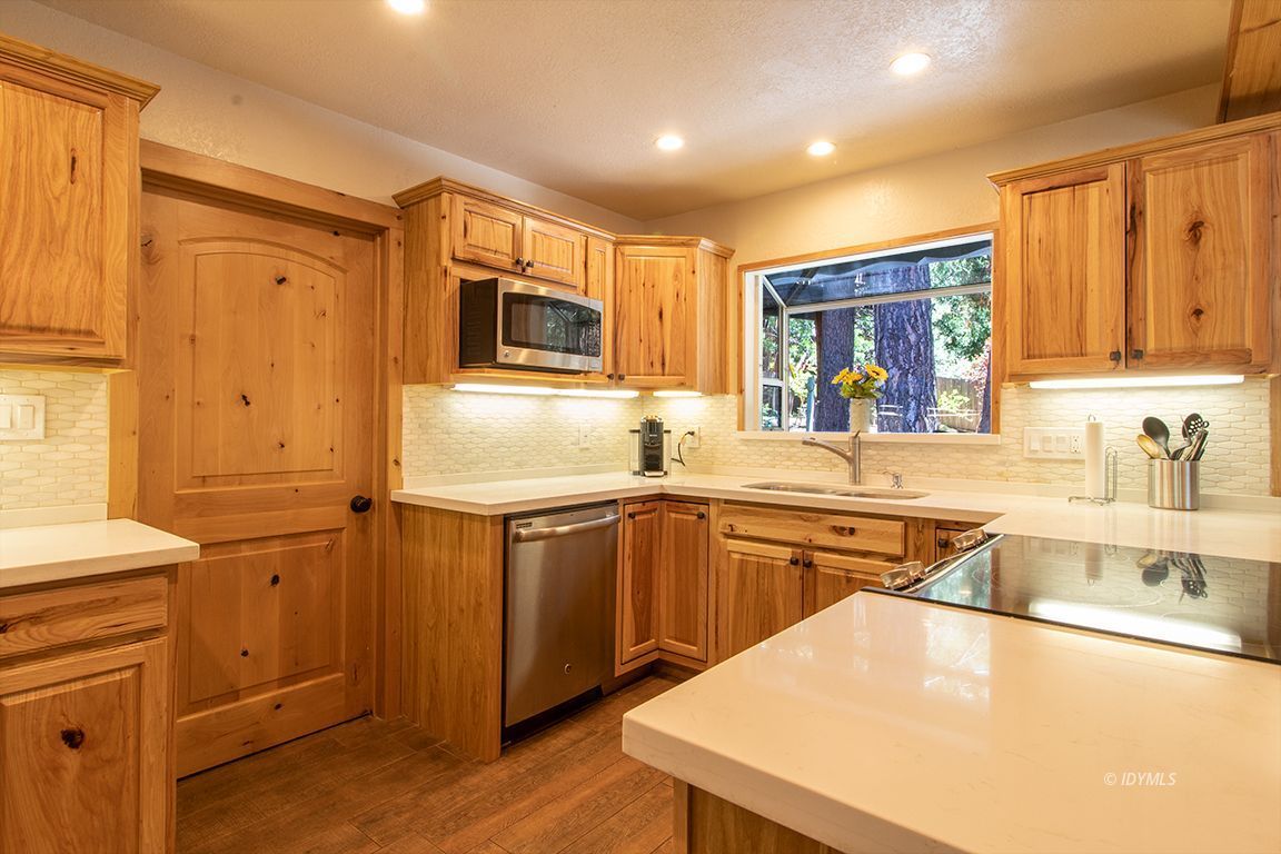 25104 Fern Valley Road Idyllwild, CA 92549 - Photo 10 of 55 a kitchen with stainless steel appliances granite countertop a sink stove and refrigerator