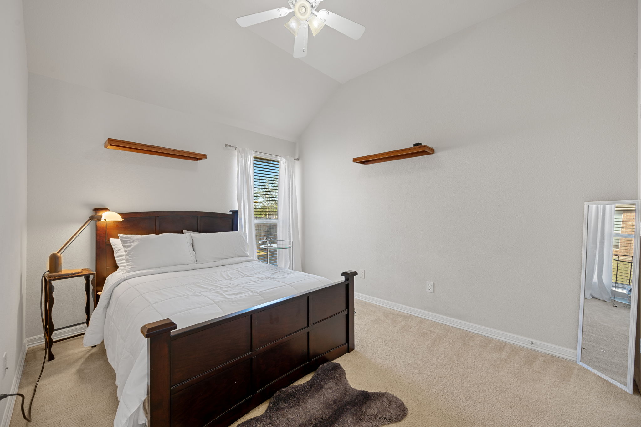 2221 Village View Loop Pflugerville, TX 78660 - Photo 16 of 25 a bedroom with a bed and a chandelier