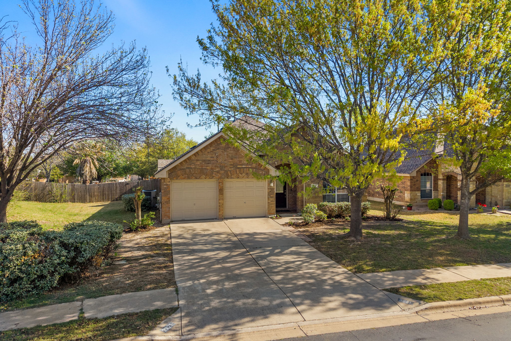 2221 Village View Loop Pflugerville, TX 78660 - Photo 3 of 25 a front view of a house with a yard and garage