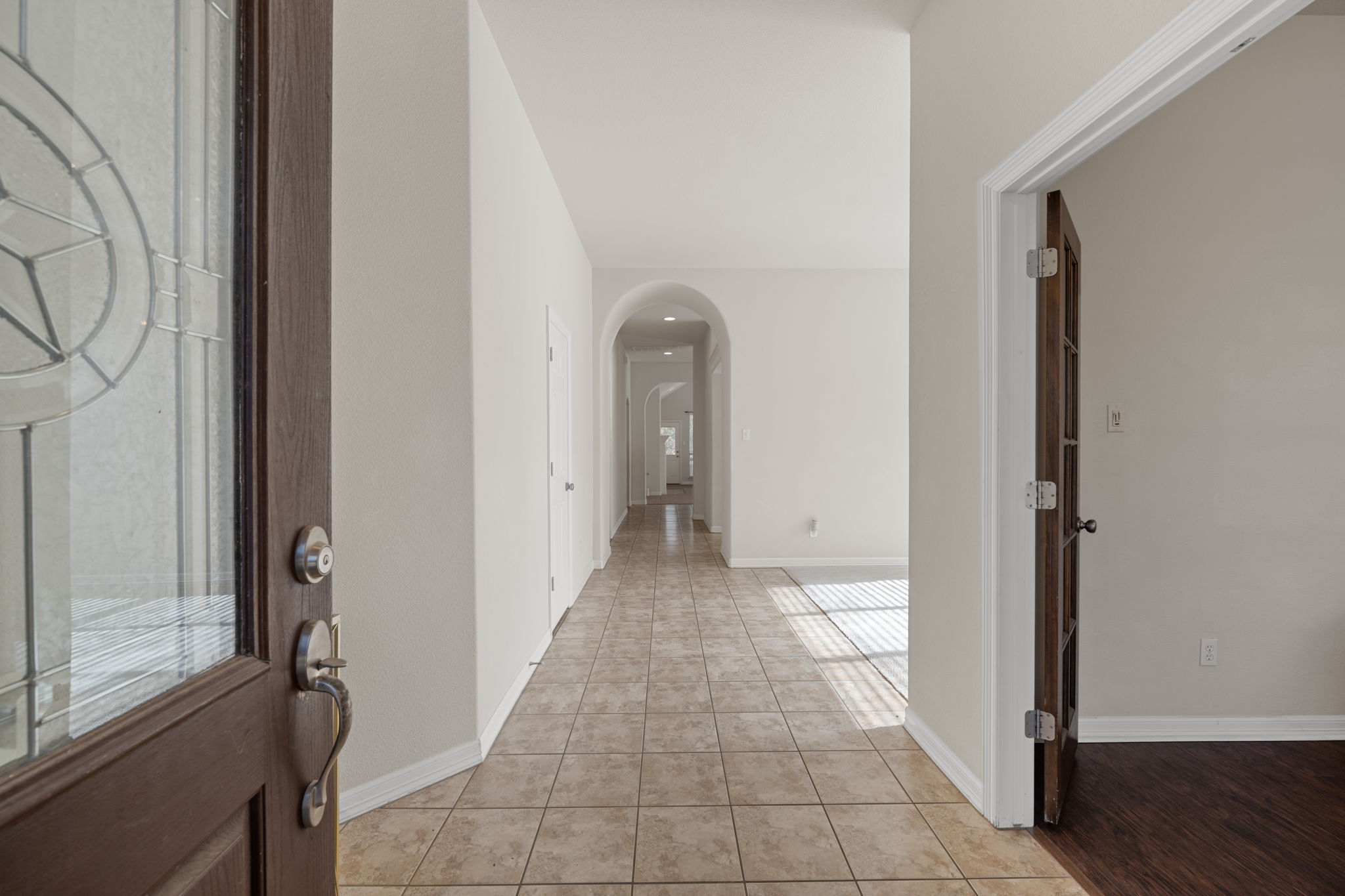 2221 Village View Loop Pflugerville, TX 78660 - Photo 5 of 25 a view of a hallway with wooden floor and a bathroom