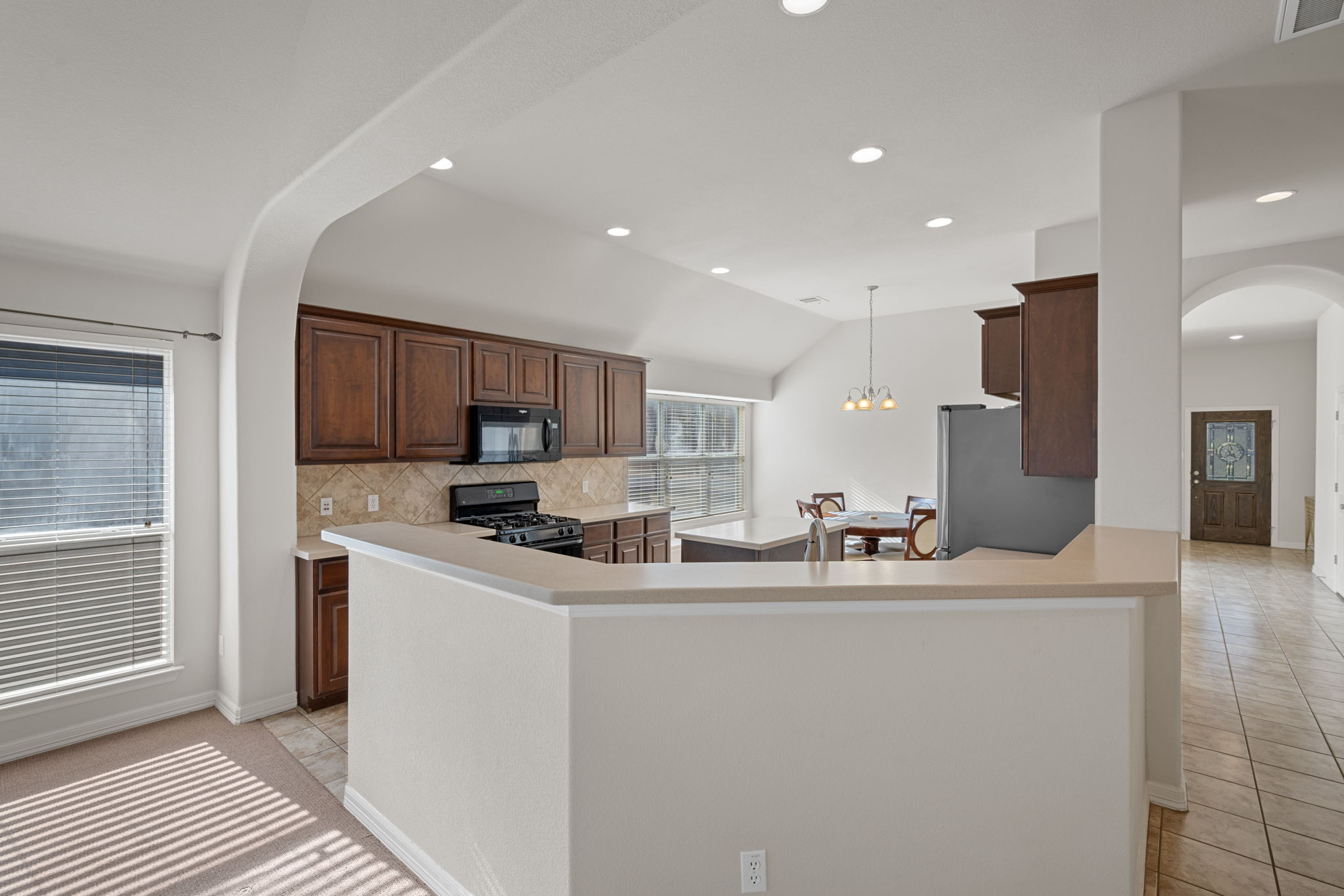 2221 Village View Loop Pflugerville, TX 78660 - Photo 8 of 25 a kitchen with stainless steel appliances a sink stove and cabinets