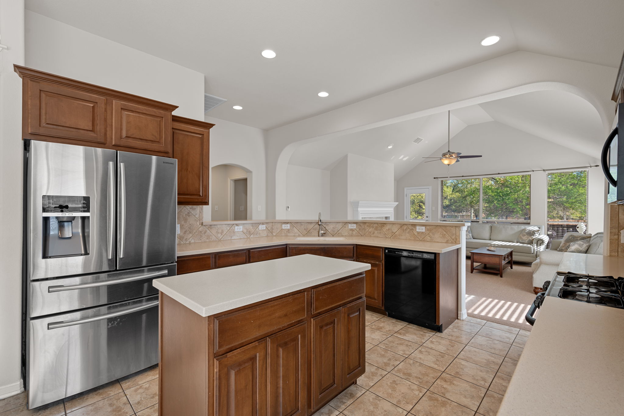2221 Village View Loop Pflugerville, TX 78660 - Photo 10 of 25 a kitchen with kitchen island a sink stove and refrigerator