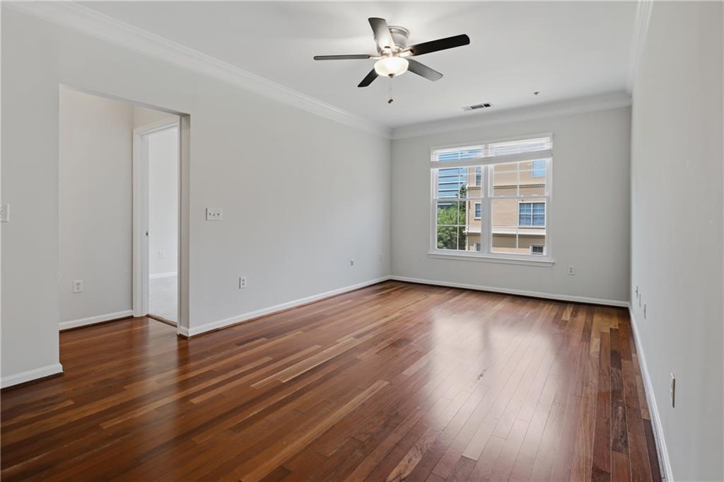10 Perimeter Summit Boulevard, Unit 3311 Atlanta, GA 30319 - Photo 54 of 68 an empty room with wooden floor ceiling fan and windows