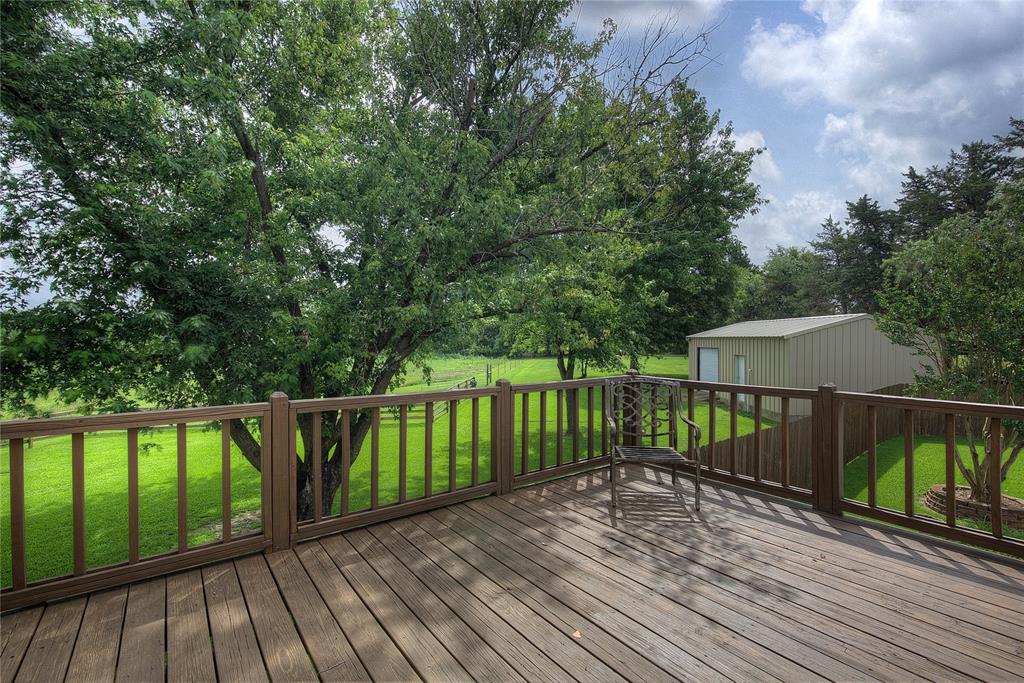 753 County Rd SW 3110 Mount Vernon, TX 75457 - Photo 27 of 40 This deck on the second floor is accessible through the primary suite. It overlooks the back yard/pool and the adjoining acreage