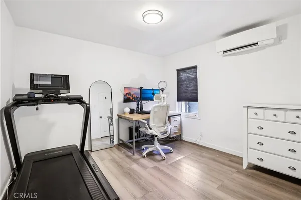 a view of a workspace with furniture and a window