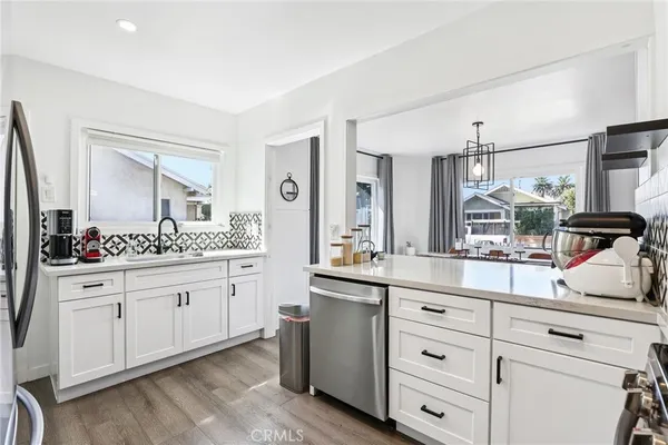 a kitchen with sink stove and cabinets