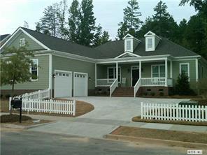 a view of a house with a deck and a yard