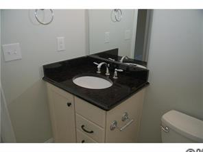 1066 Gardenia Street Fort Mill, SC 29708 - Photo 9 of 12 a bathroom with a sink and a mirror