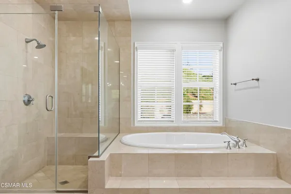 a bathroom with a bathtub and shower