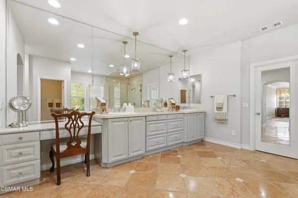 a large white kitchen with a sink and dishwasher