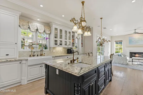 a kitchen with center island table and chairs in it