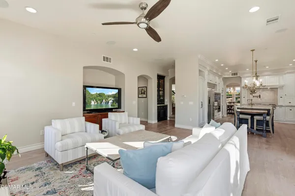 a living room with furniture and a chandelier