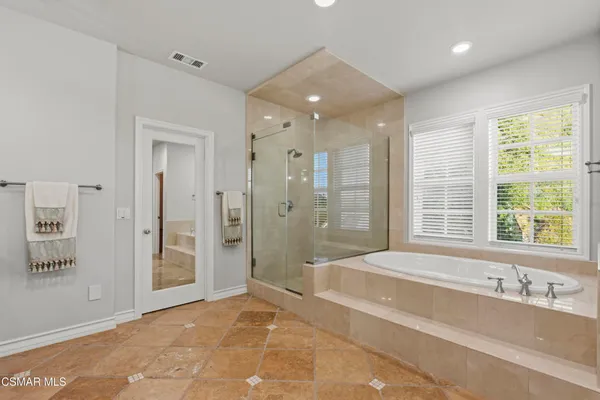 a spacious bathroom with a granite countertop tub shower and sink