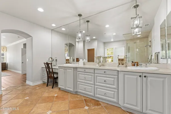 a bathroom with a sink vanity and a mirror