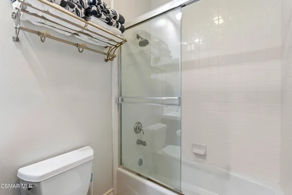 a bathroom with a shower and toilet