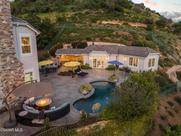 an aerial view of a house with yard swimming pool and outdoor seating