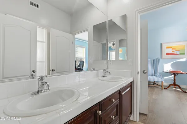 a bathroom with a sink double vanity and a mirror