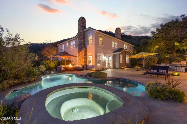 a swimming pool with outdoor seating and yard