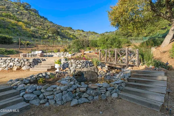 a view of a yard with wooden fence