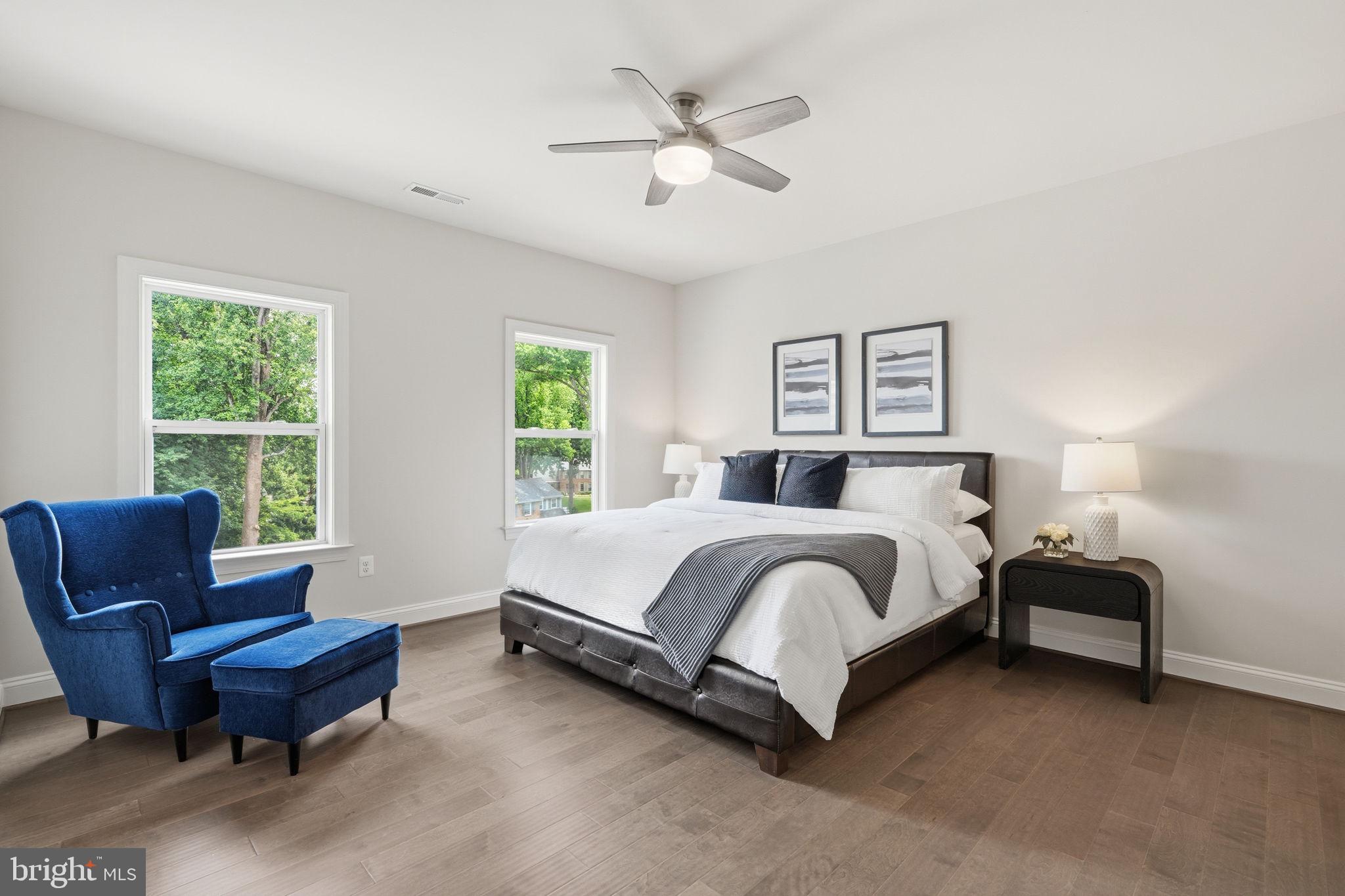 7821 Old Falls Road McLean, VA 22102 - Photo 32 of 62 a spacious bedroom with a bed and a couch