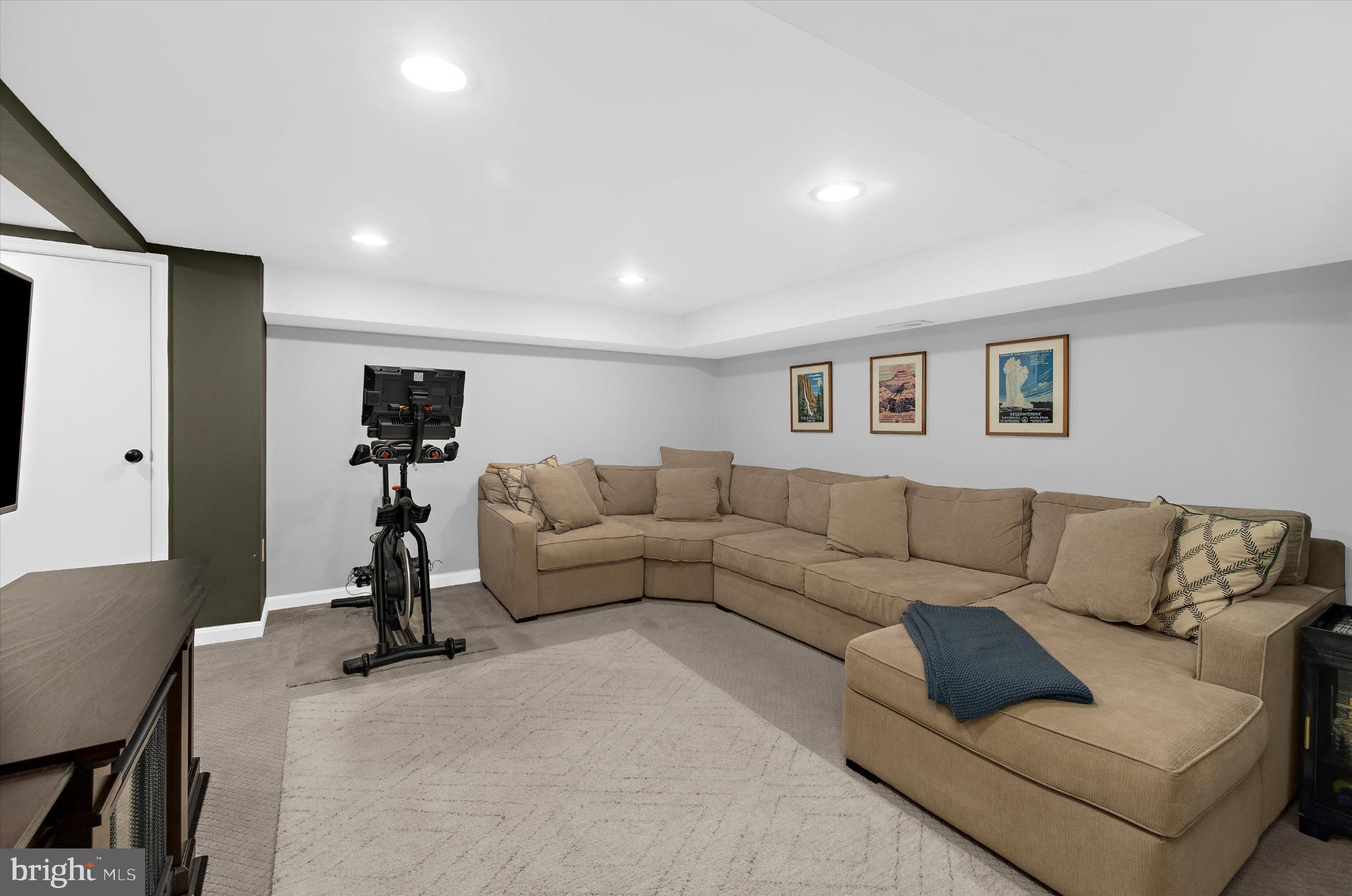 1215 Roland Heights Avenue Baltimore, MD 21211 - Photo 23 of 38 a living room with furniture and a flat screen tv