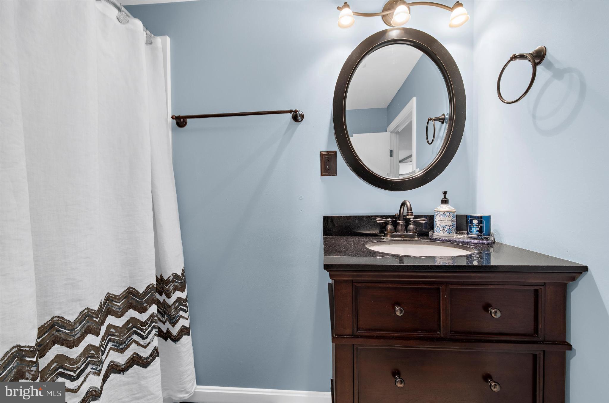 1215 Roland Heights Avenue Baltimore, MD 21211 - Photo 25 of 38 a bathroom with a sink and a mirror