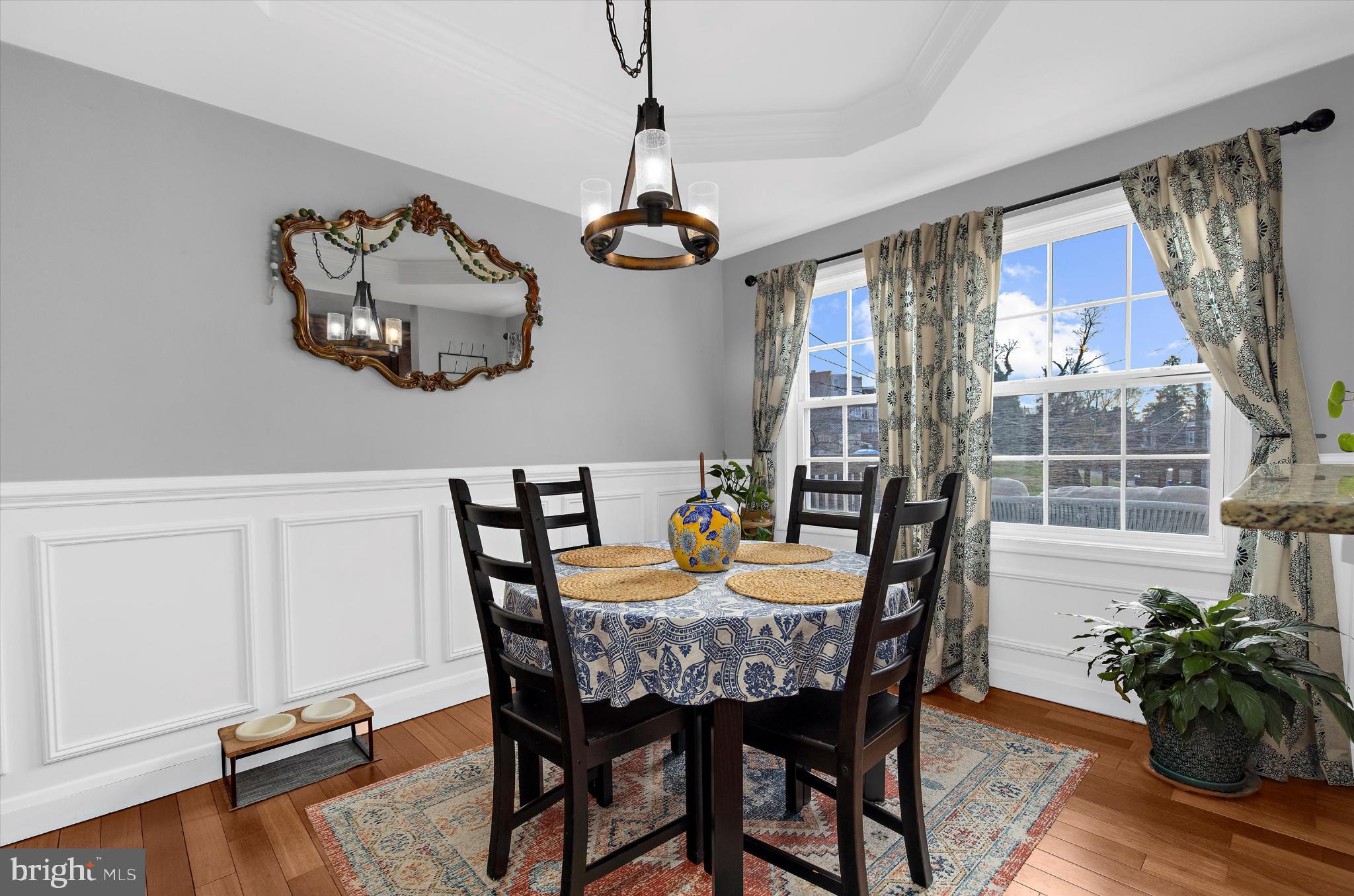 1215 Roland Heights Avenue Baltimore, MD 21211 - Photo 10 of 38 a dining room with furniture potted plants and wooden floor