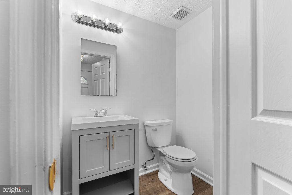 3 Ramsgate Court Halethorpe, MD 21227 - Photo 11 of 30 a bathroom with a toilet a sink and mirror