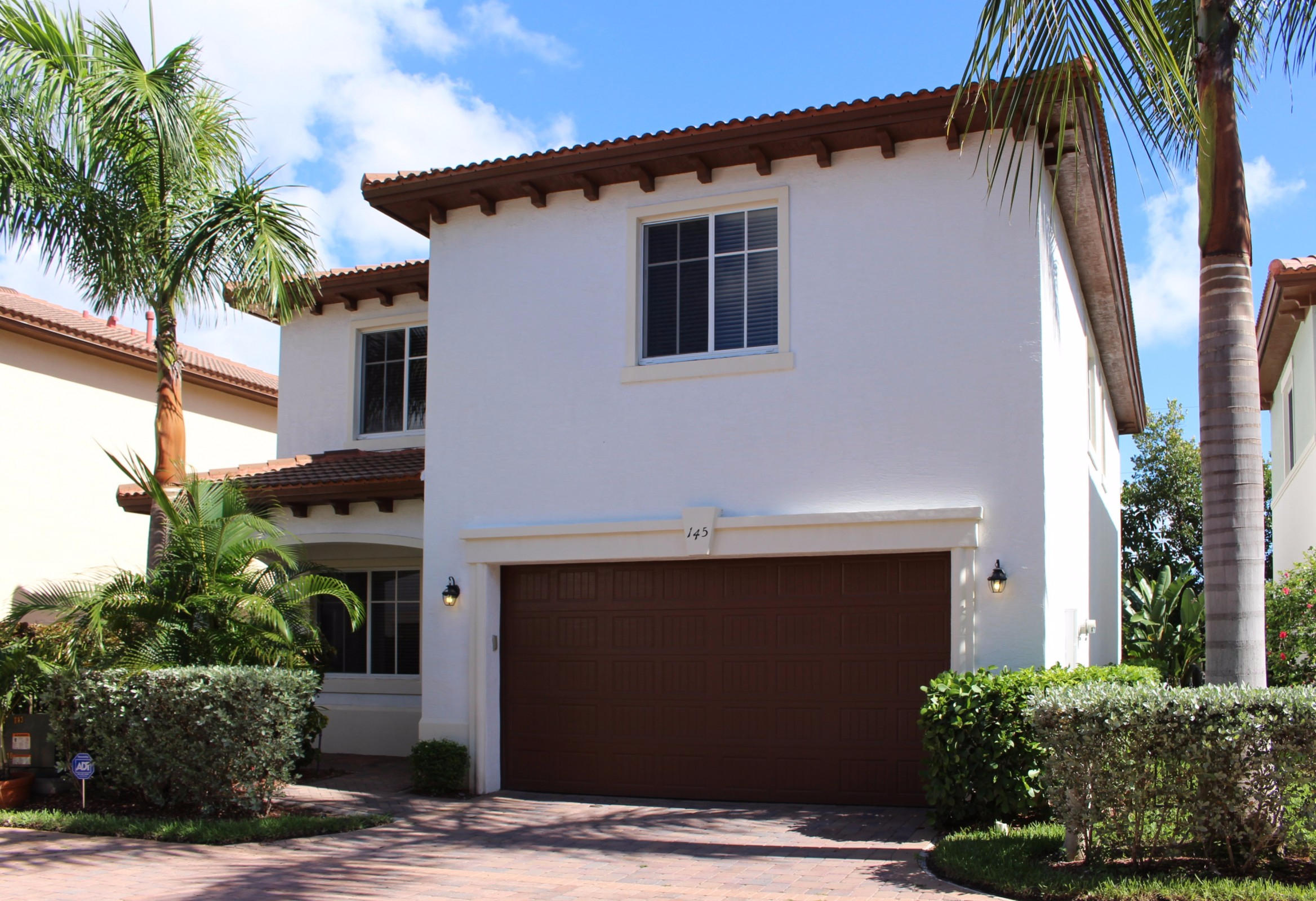 145 Northwest Emerson Place Boca Raton, FL 33432 - Photo 1 of 35 a front view of house with yard