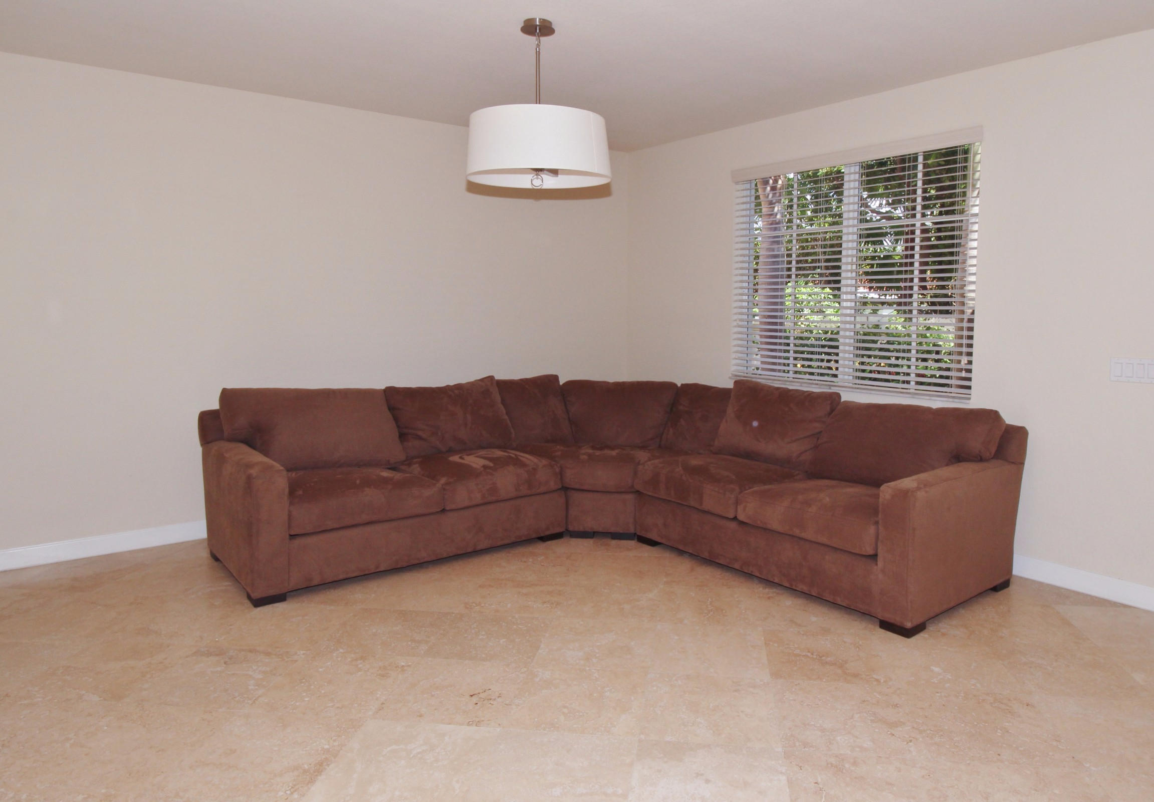145 Northwest Emerson Place Boca Raton, FL 33432 - Photo 11 of 35 a living room with furniture a large window and a chandelier