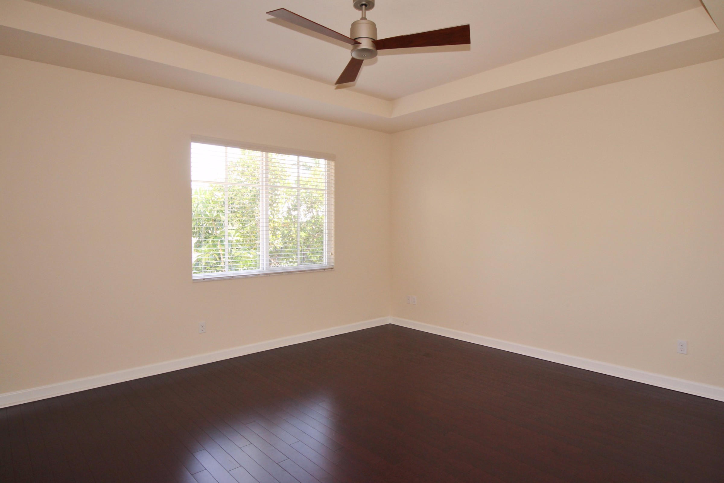 145 Northwest Emerson Place Boca Raton, FL 33432 - Photo 14 of 35 an empty room with wooden floor and windows