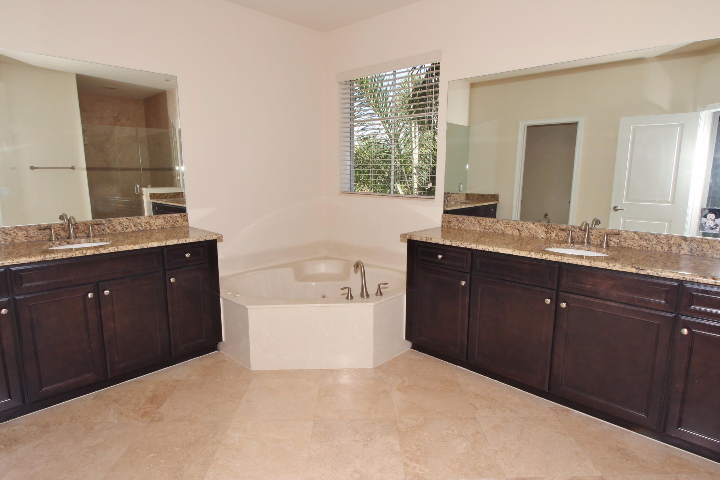 145 Northwest Emerson Place Boca Raton, FL 33432 - Photo 16 of 35 a spacious bathroom with a tub double sink mirror and
