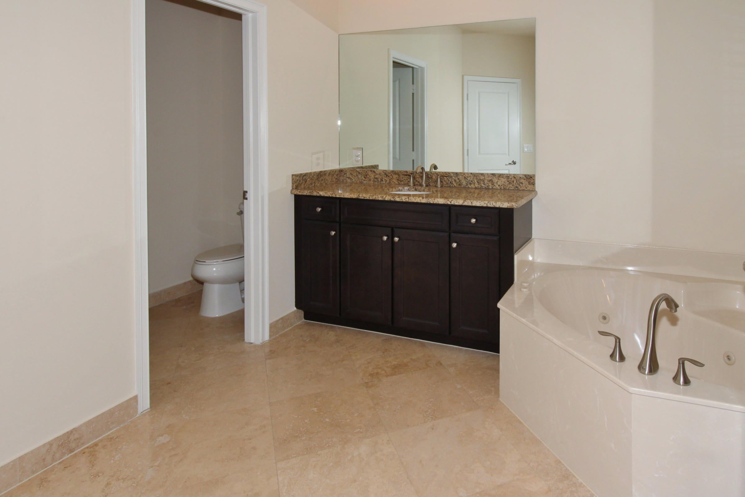145 Northwest Emerson Place Boca Raton, FL 33432 - Photo 17 of 35 a bathroom with a granite countertop sink a toilet and a tub