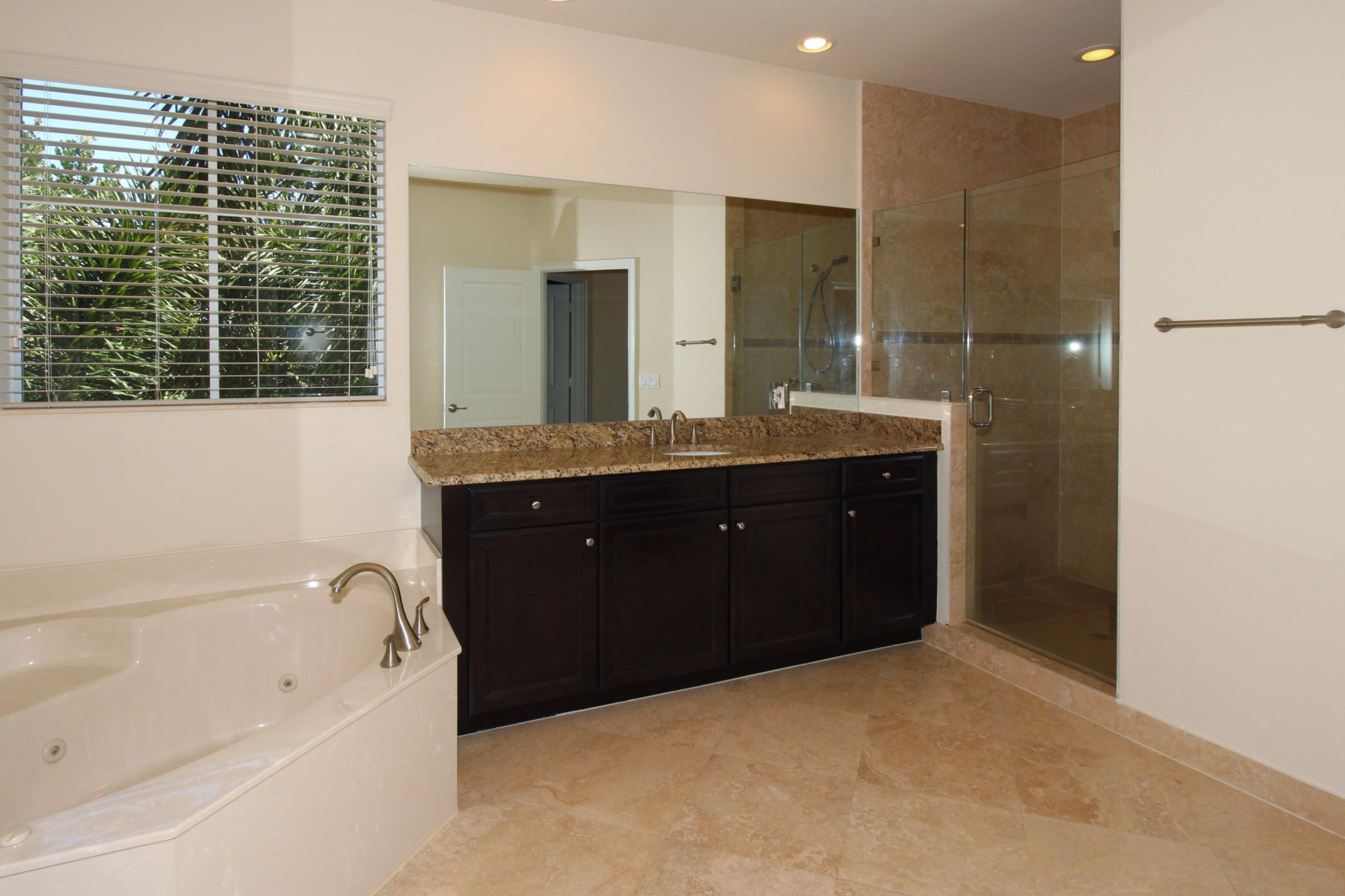 145 Northwest Emerson Place Boca Raton, FL 33432 - Photo 18 of 35 a spacious bathroom with a tub sink shower and mirror