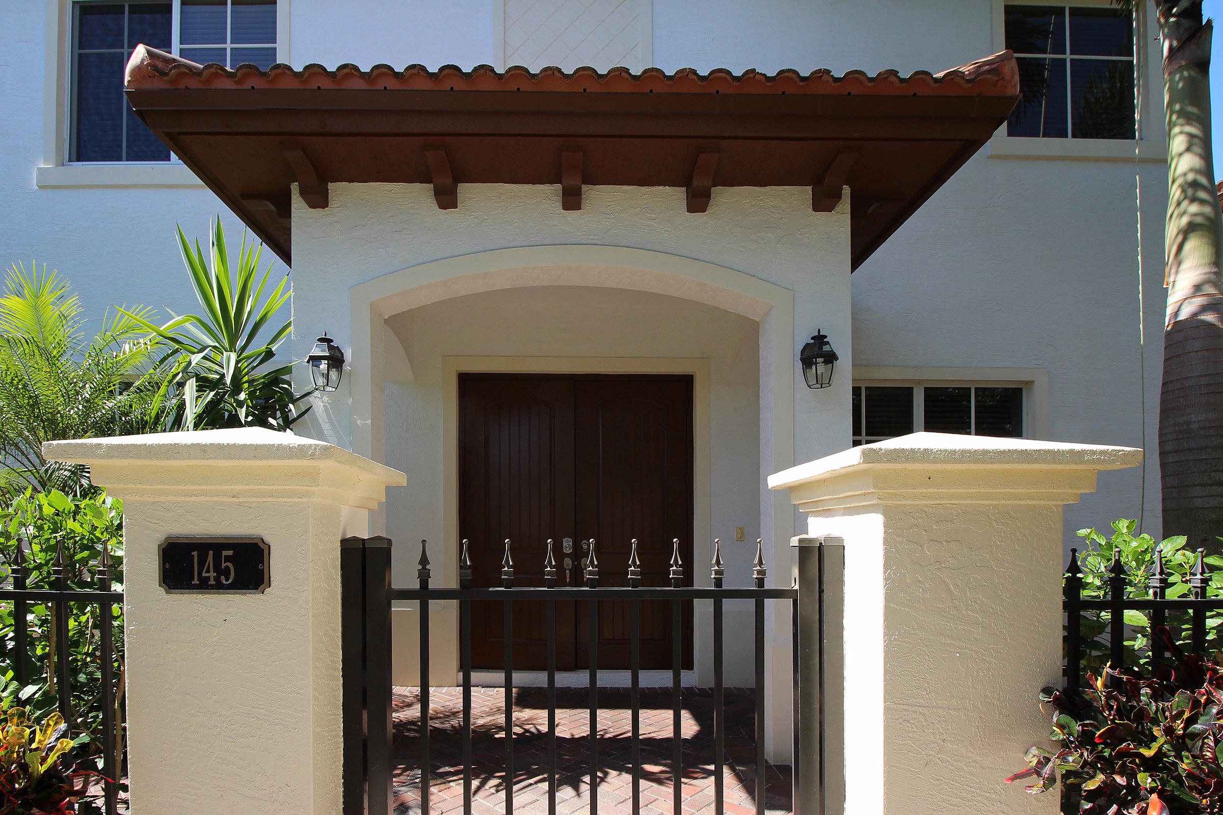 145 Northwest Emerson Place Boca Raton, FL 33432 - Photo 2 of 35 a front view of a house with balcony
