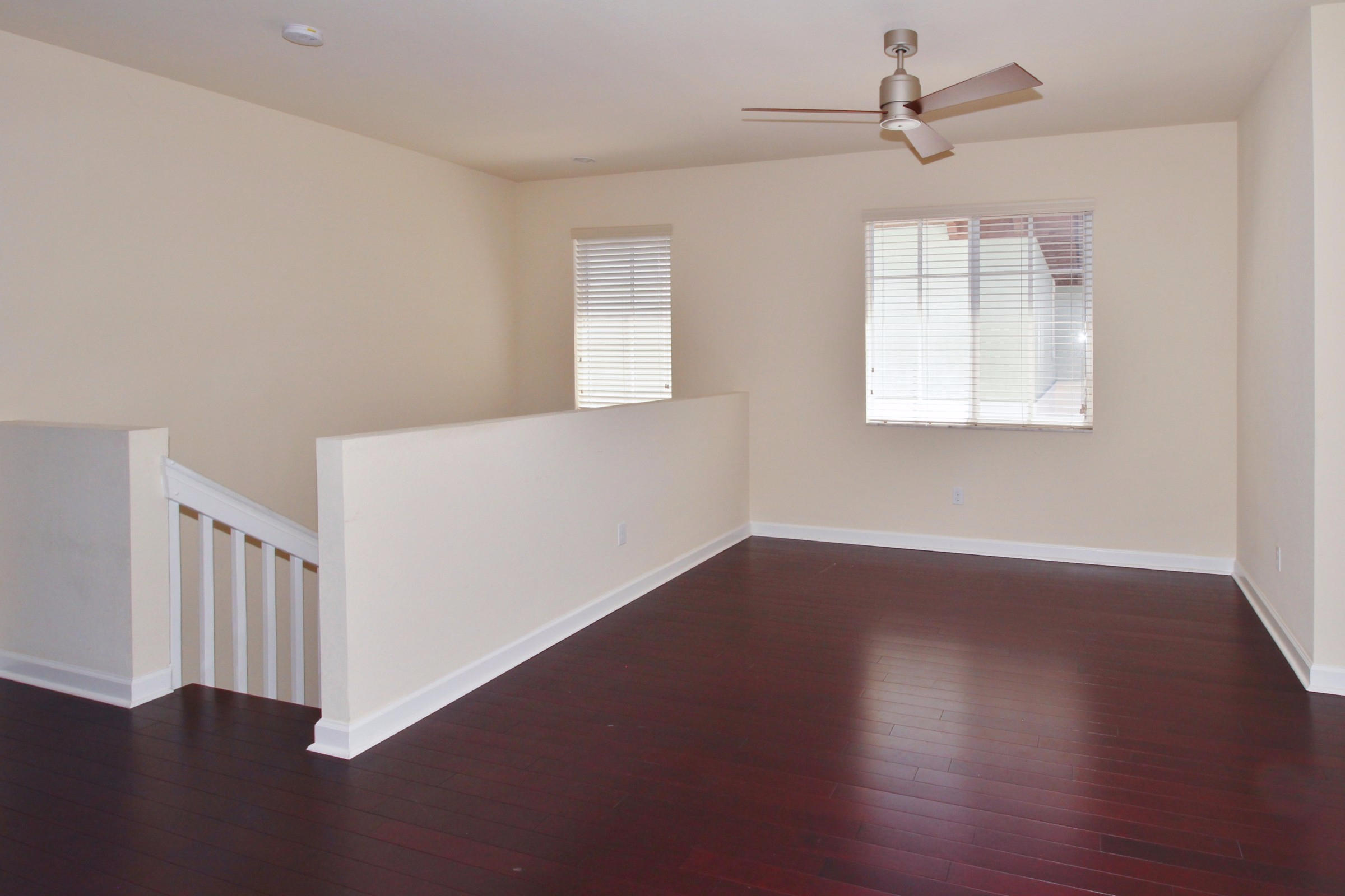 145 Northwest Emerson Place Boca Raton, FL 33432 - Photo 25 of 35 a view of an empty room with wooden floor and a window